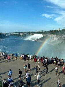 Tourists watching rainbow at Niagara Falls overlook